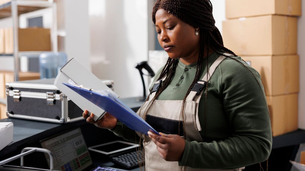 cashier behind counter reading a document